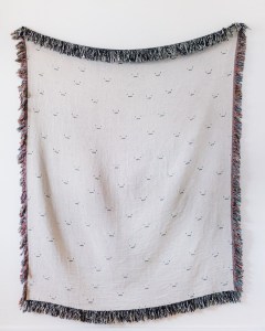 The Cute Faces blanket by Frankie Print Co.